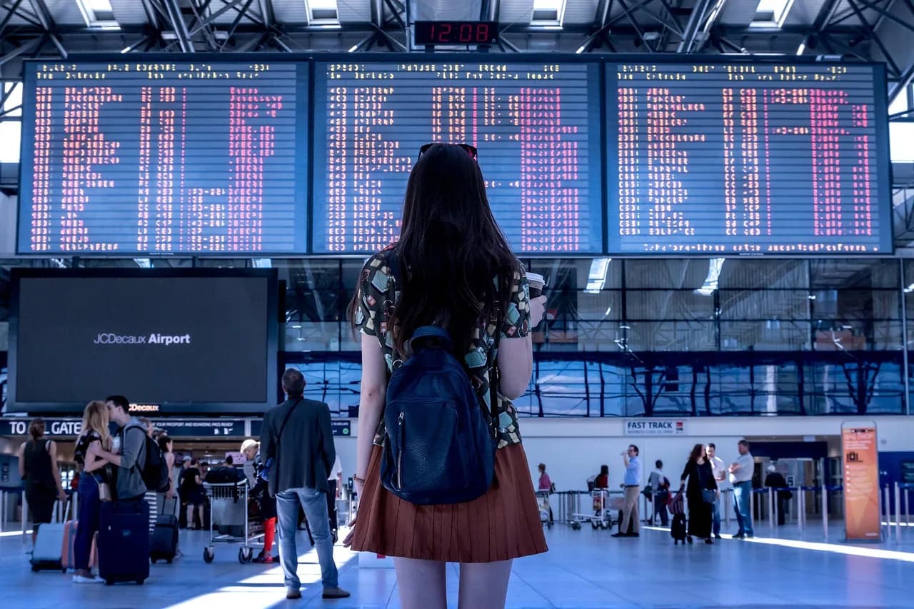 Traveller with luggage at the airport arrival terminal